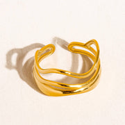Gold open ring on a light beige background